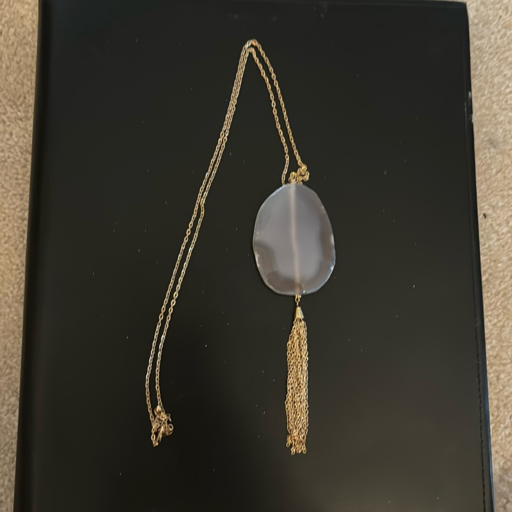 Long gold chain with large lavender colored geode.